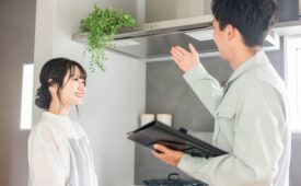 換気扇の説明をする作業着の男性と女性